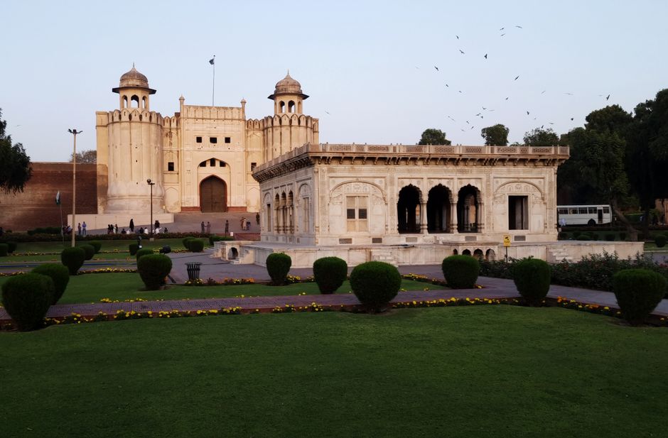 Historic Shahi Qila Lahore Fort showing Mughal architecture with red sandstone walls and ornate domes against blue sky